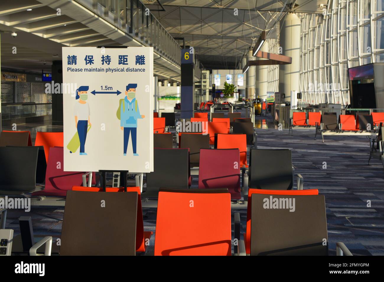 Covid physical distancing sign in an empty Chek Lap kok, Hong Kong international airport. Not many passengers flying with the current restrictions. Stock Photo