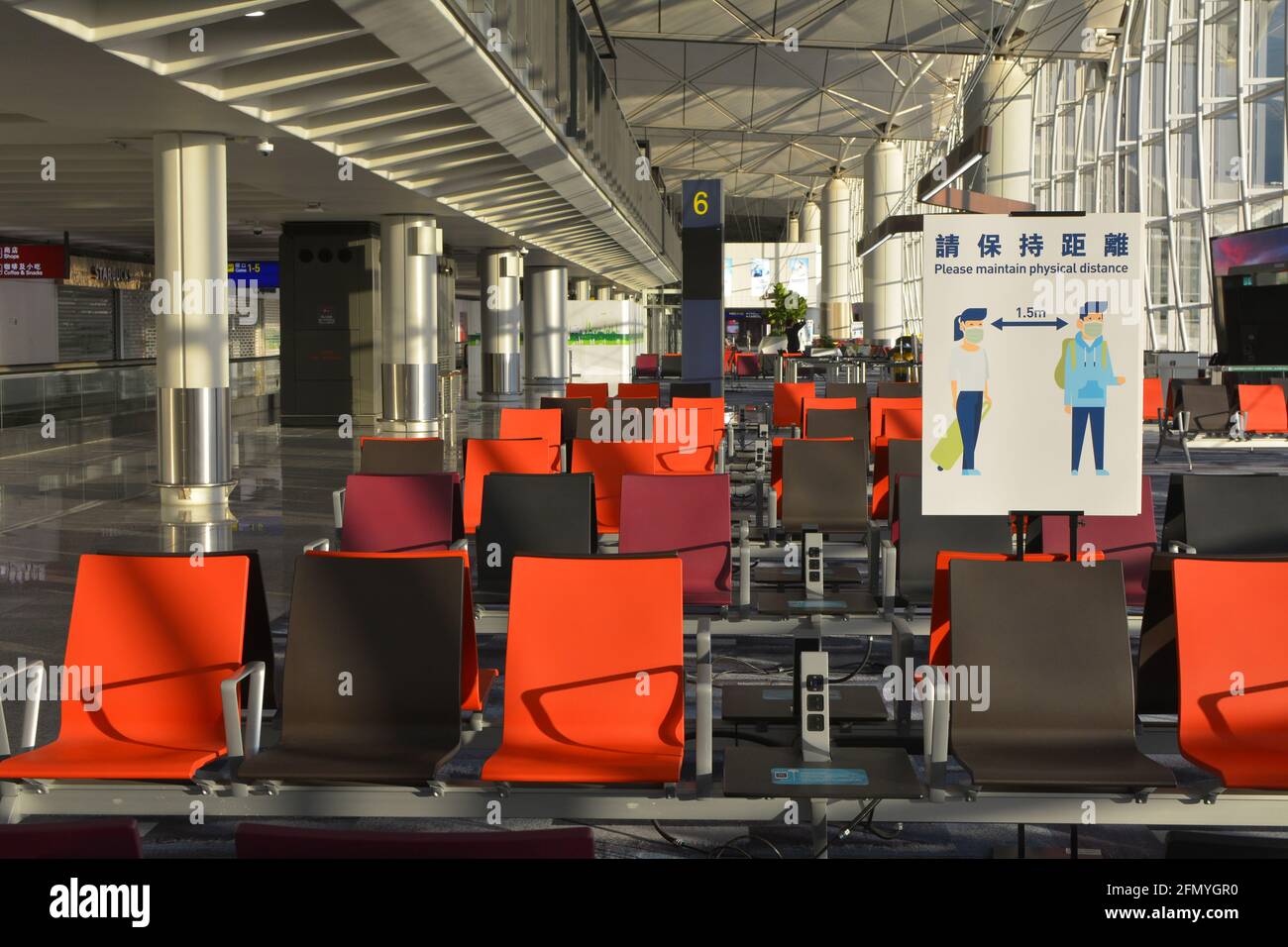 Covid physical distancing sign in an empty Chek Lap kok, Hong Kong international airport. Not many passengers flying with the current restrictions. Stock Photo
