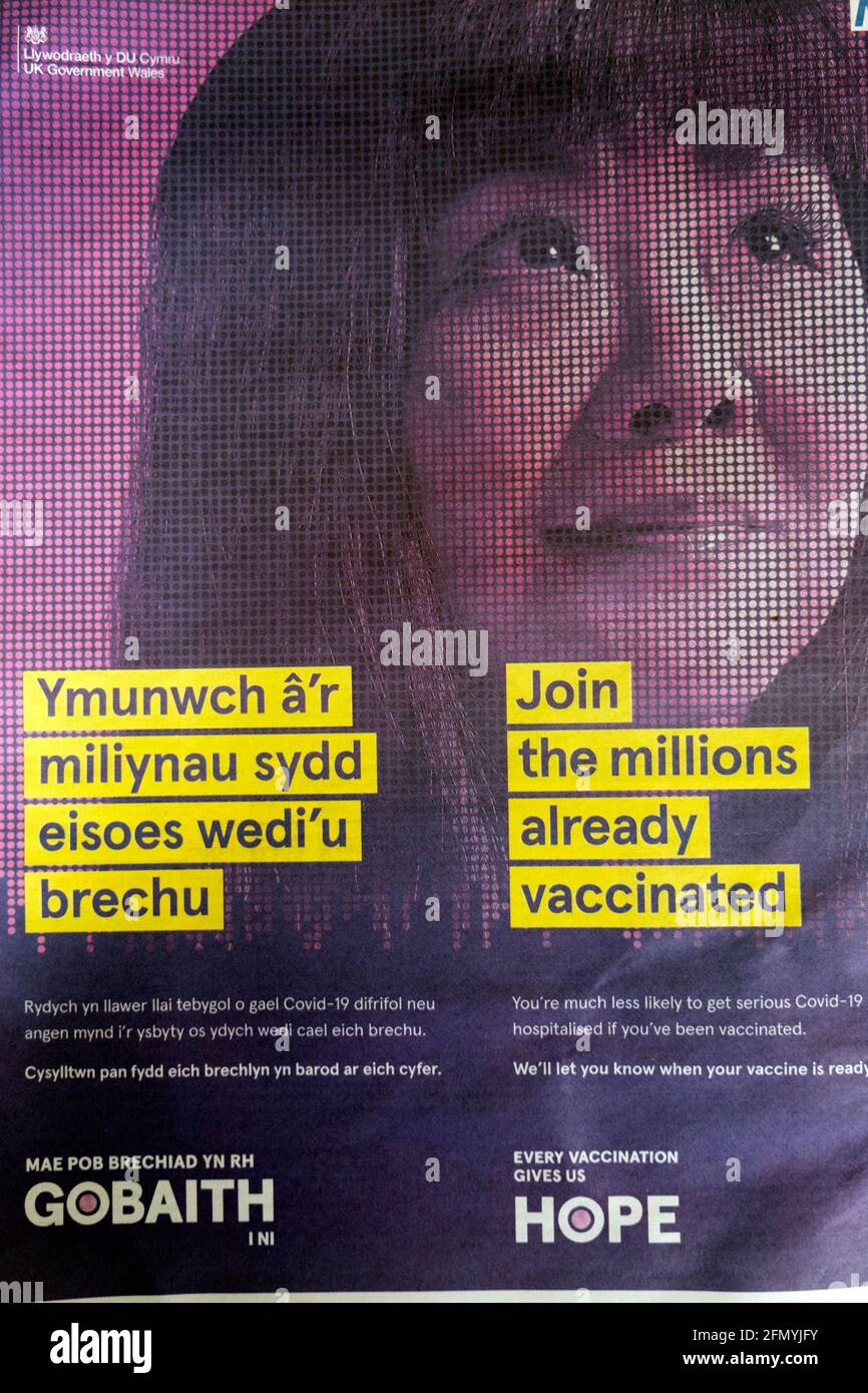 'Join the Millions already vaccinated' Welsh language Gobaith Hope Covid-19 vaccination advertisement in the Guardian newspaper April 2021 London UK Stock Photo