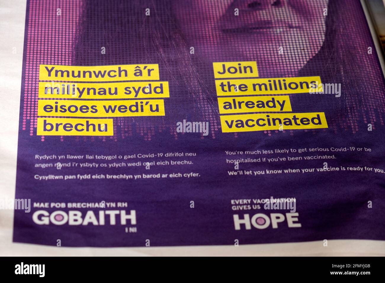 'Join the Millions already vaccinated' Welsh language Gobaith Hope Covid-19 vaccination advertisement in the Guardian newspaper April 2021 London UK Stock Photo