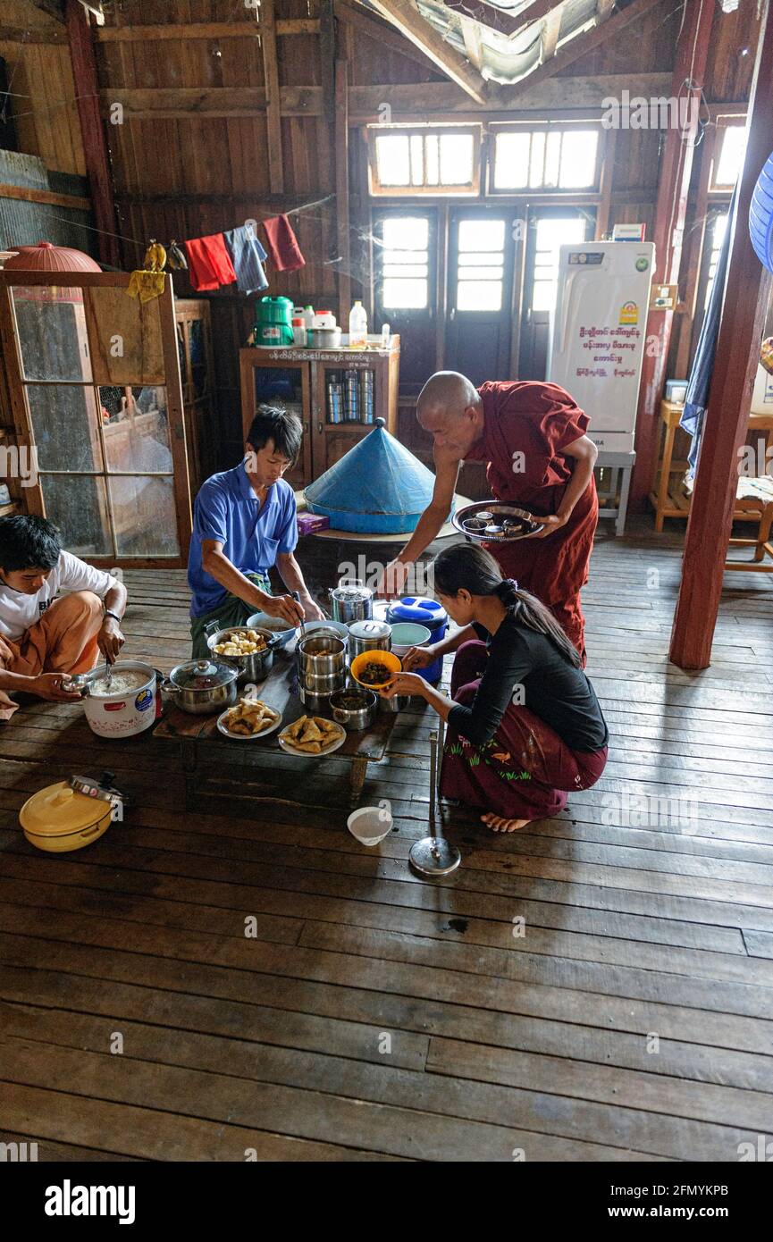 Local villagers provide lunch for Buddhist monks at the Nga Phe Chaung monastery, also known as the Jumping Cat Monastery Stock Photo