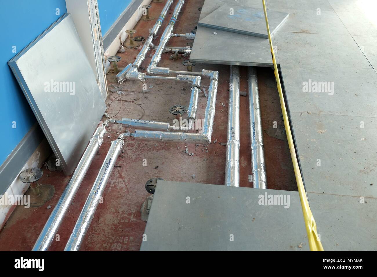 March 2016 - lifted raised flooring access panels to enable works to be completed and for the void to be cleaned Stock Photo