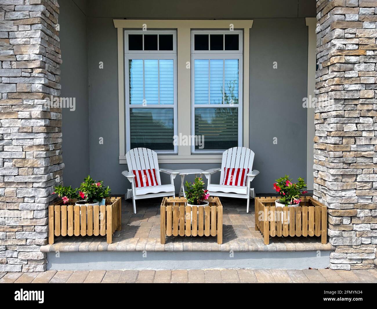 A cozy peaceful front porch of a house with adirondack chairs and flower  planters in Laureate Park Lake Nona in Orlando, Florida Stock Photo - Alamy