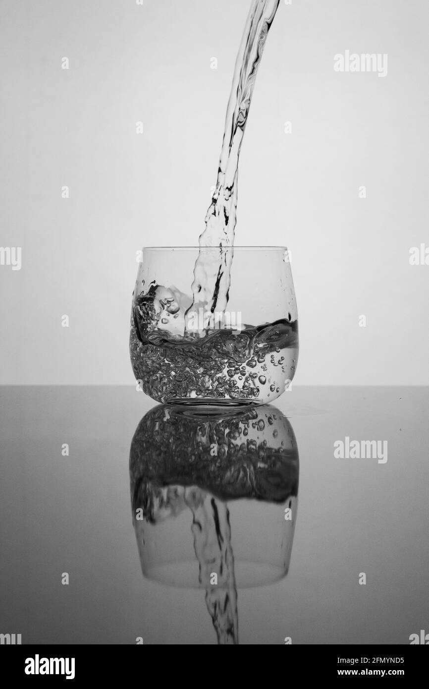 pouring water into glass Stock Photo - Alamy