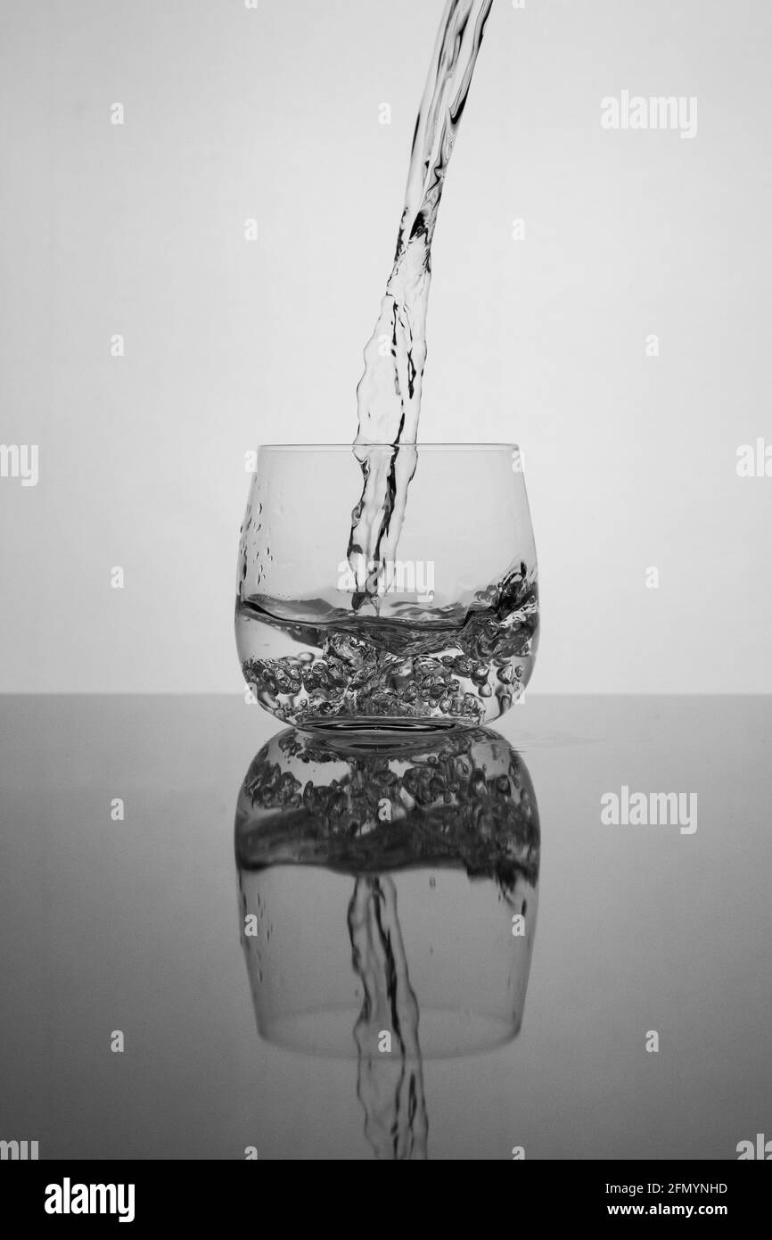 pouring water into glass Stock Photo - Alamy