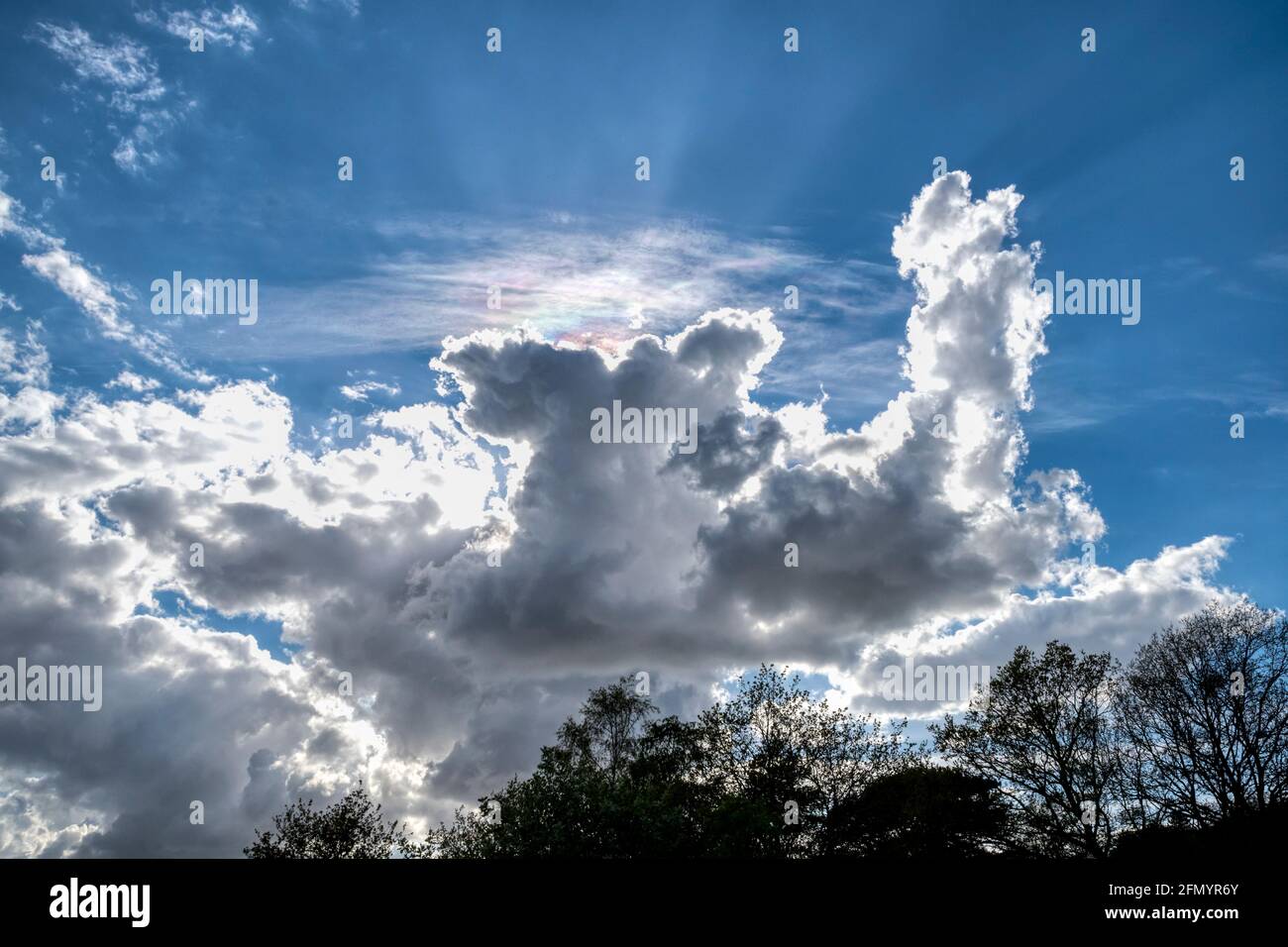 The sun behind dramatic cumulus clouds over Norfolk. Stock Photo