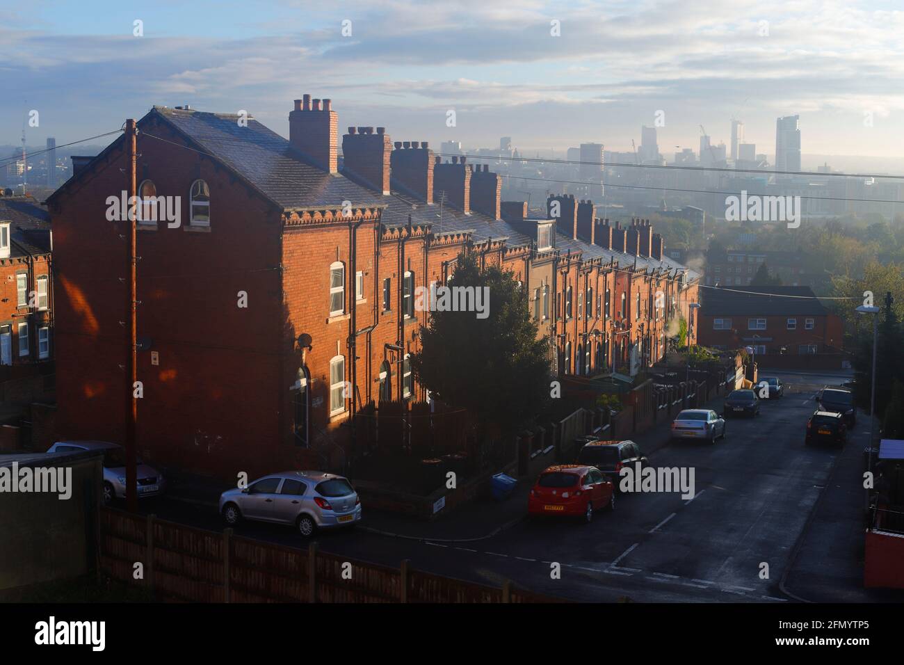 Back to back houses overlooking modrrn architecture in Leeds City