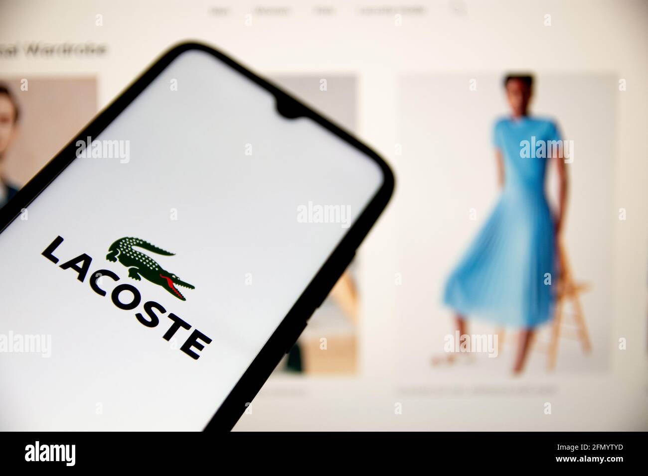 Greece. 12th May, 2021. In this photo illustration a Lacoste logo seen displayed on a smartphone screen with a Lacoste website in the background. (Photo by Nikolas Joao Kokovlis/SOPA Images/Sipa USA) Credit: Sipa USA/Alamy Live News Stock Photo