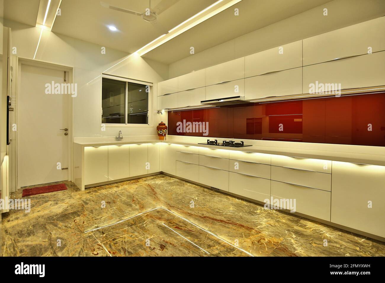 Modern designed interior of a kitchen with white and red furniture ...