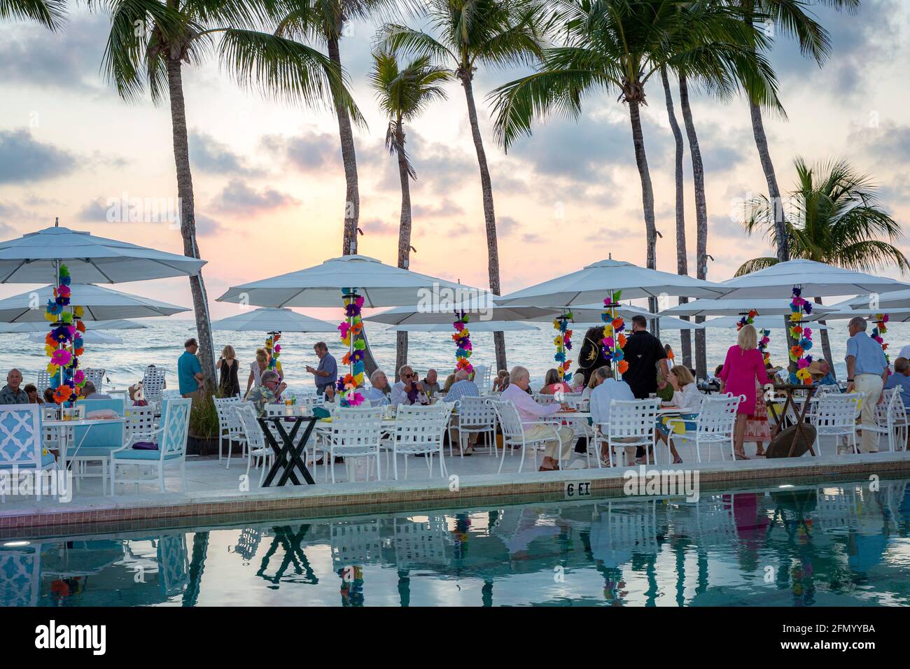 Seating and umbrellas set up at the beach for a dinner party, Naples