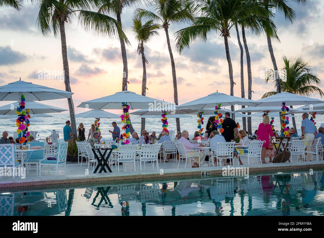 Seating and umbrellas set up at the beach for a dinner party, Naples, Florida, USA Stock Photo