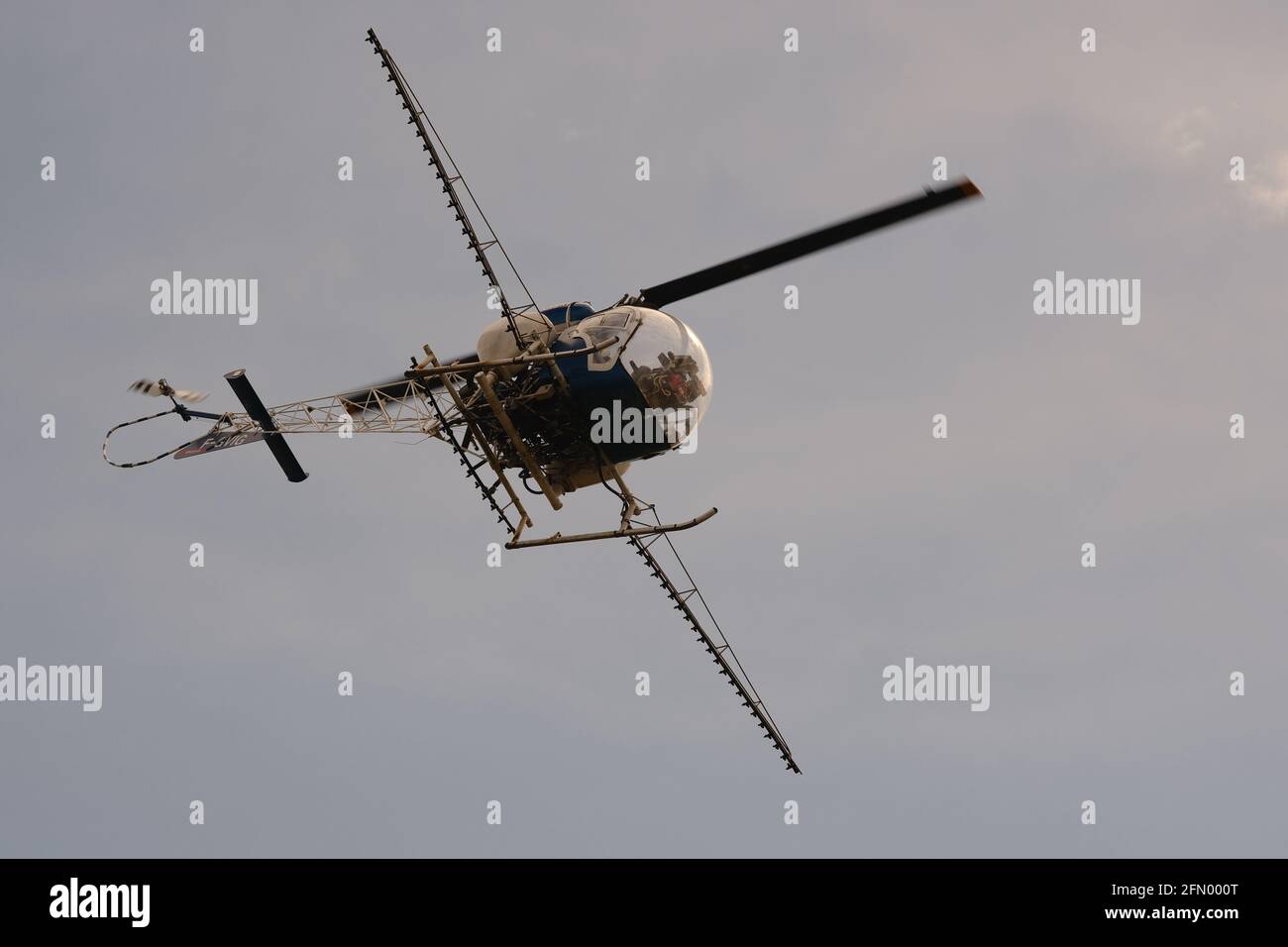 Helicopter spraying mosquito repellent in over salt lakes in Palavas