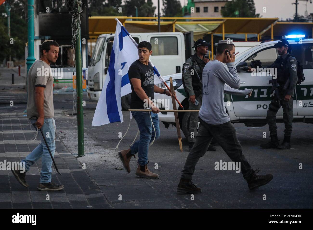 Lod, Israel. 12th May, 2021. Jewish right-wing protesters are seen marching with Israeli flags in the mixed Israeli-Arab city of Lod. A state of emergency has been declared in Lod, as tensions rise between Israelis and Arab-Israelis following the killing of an Arab during the riots on Monday night. Credit: Oren Ziv/dpa/Alamy Live News Stock Photo