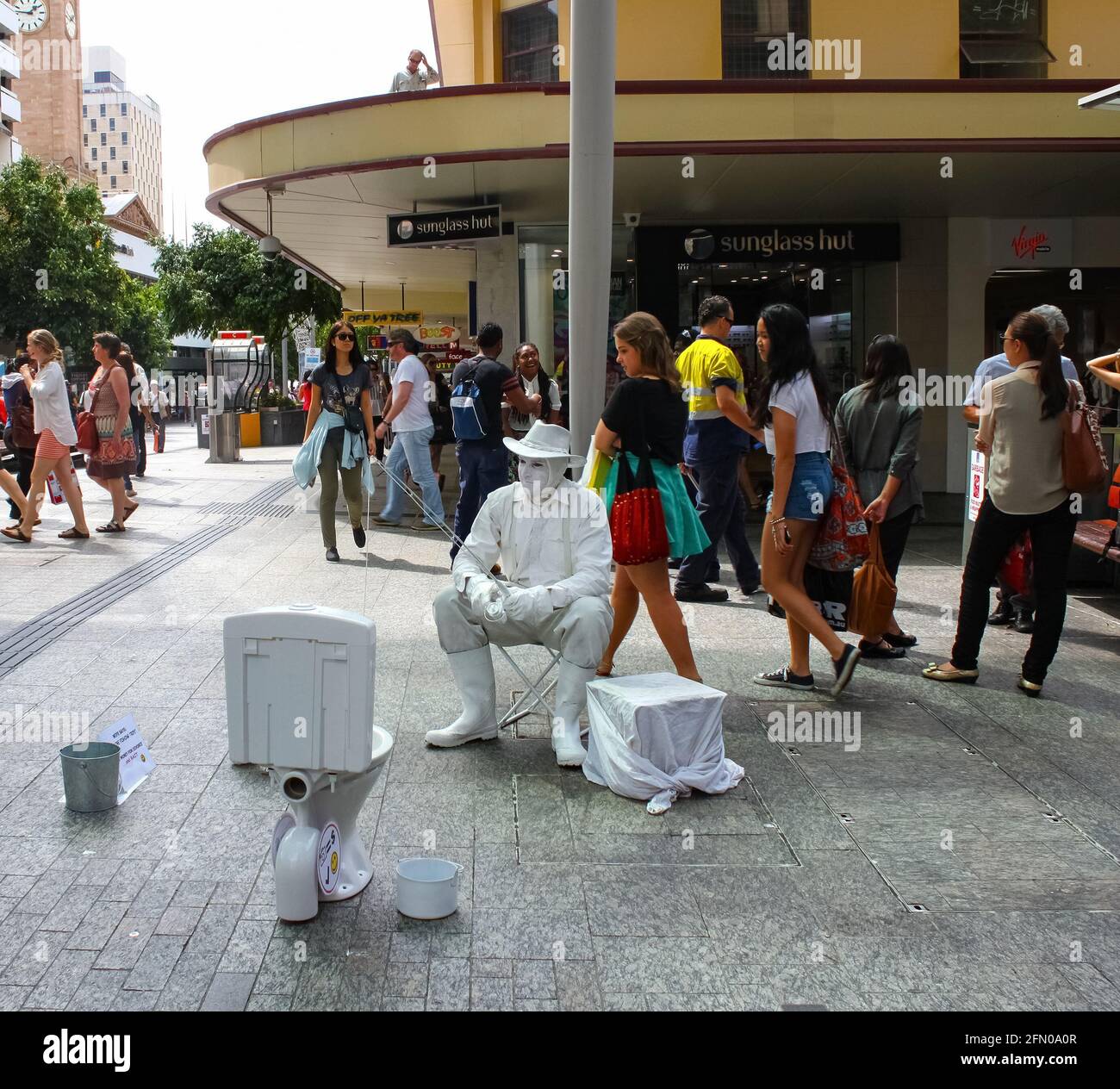 Living statue street performer on sidewalk - fisherman fishing in a toliet - Brisbane Queensland Australia November 23 2013 Stock Photo