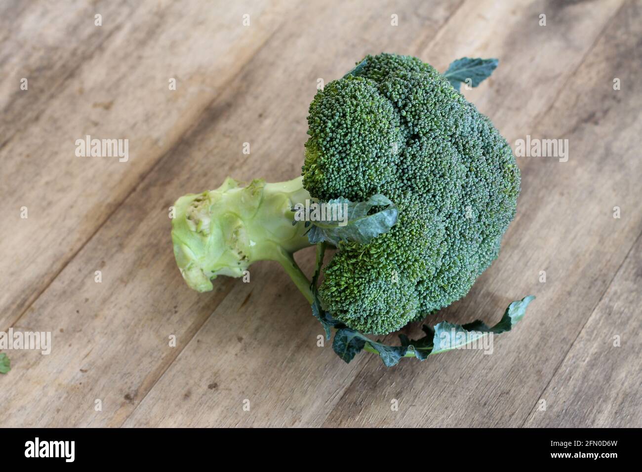 Green broccoli on wooden table for cooking Stock Photo
