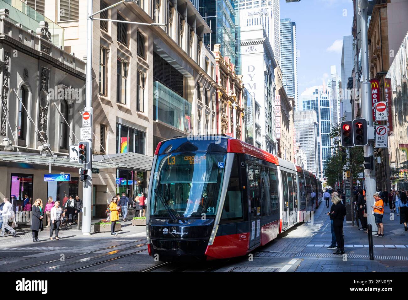George street in Sydney city centre with public transport light rail and office workers shopping,Sydney,NSW,Australia Stock Photo