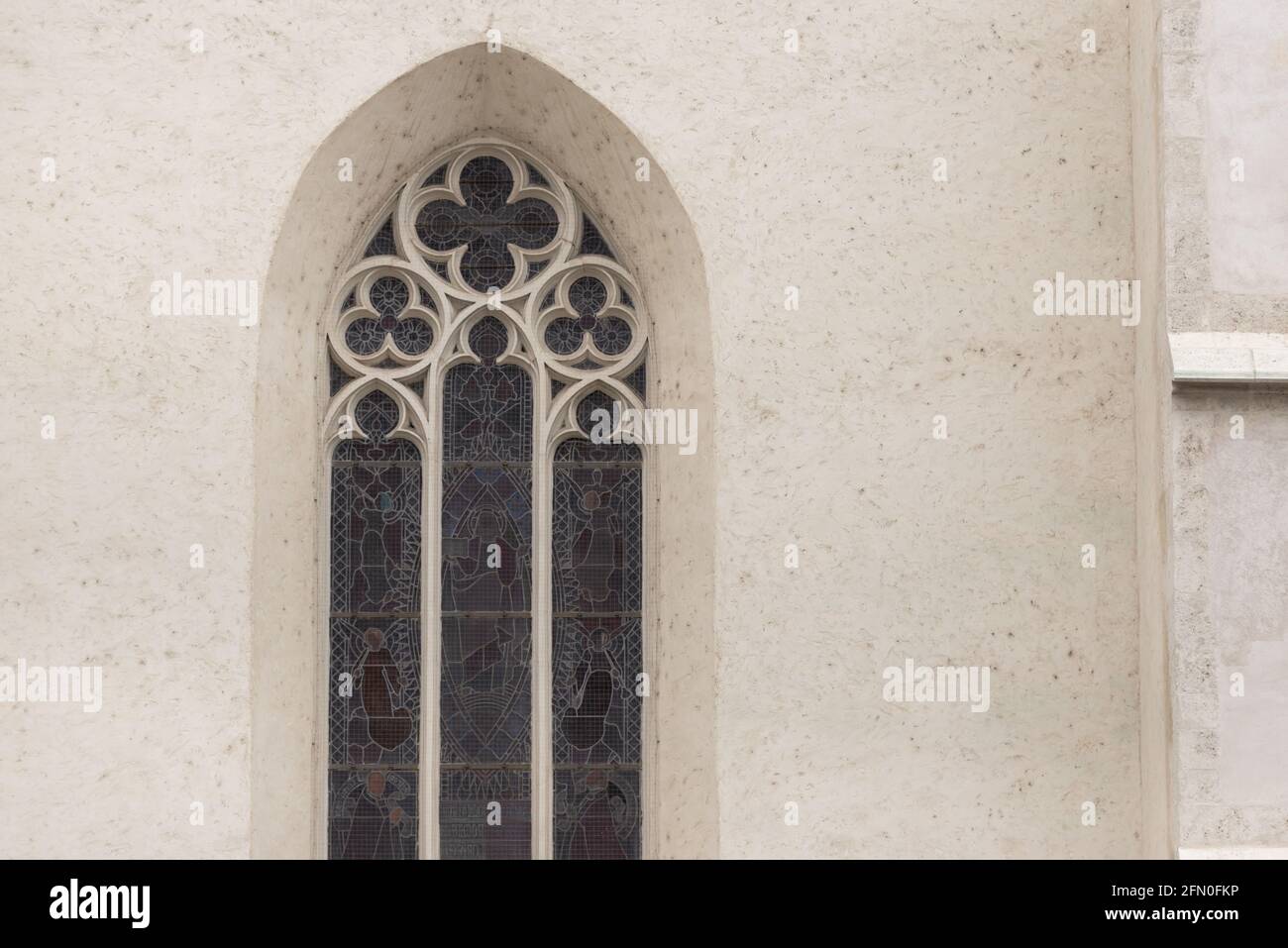 Window with stained glass windows on the old church. High arched window ...