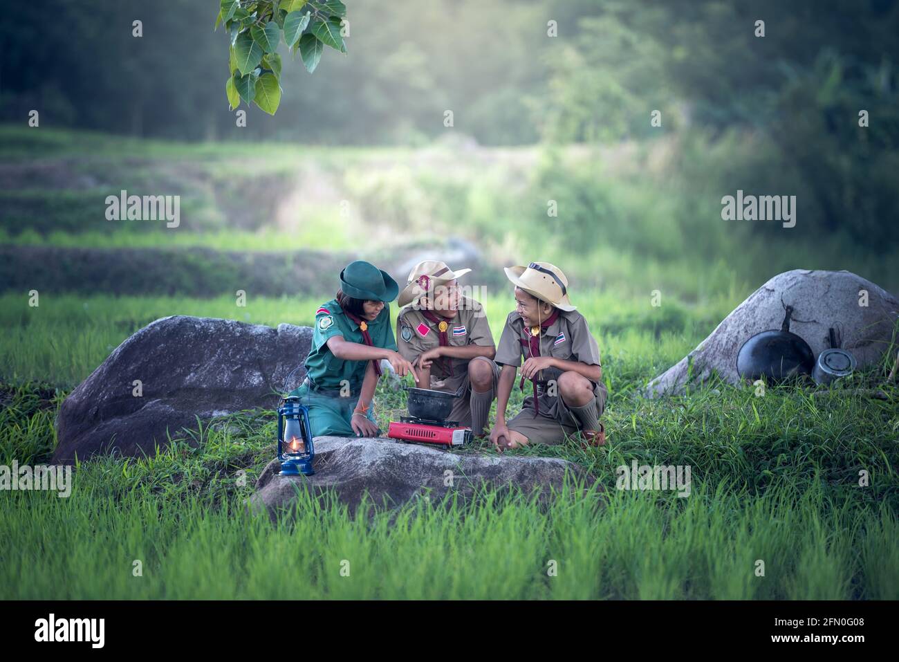 3 Boy Scouts in a Life Adventure, searching for their campsite and deciding how to proceed on the right path. Why don't we do this also in our lives? Stock Photo