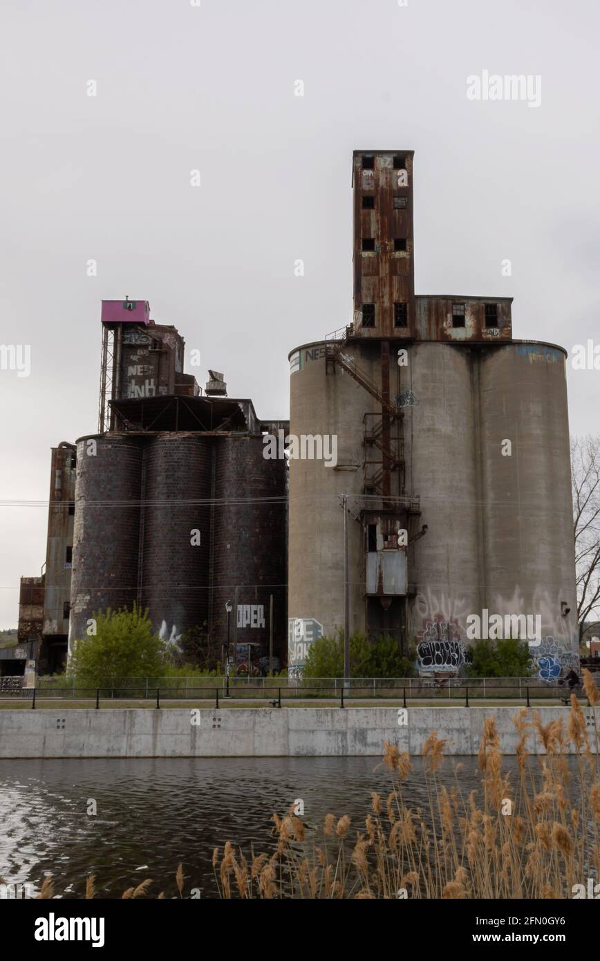 There is a strange pink cabin on top of an abandoned factory building located in front of the Canal Lachine in Montreal. Stock Photo