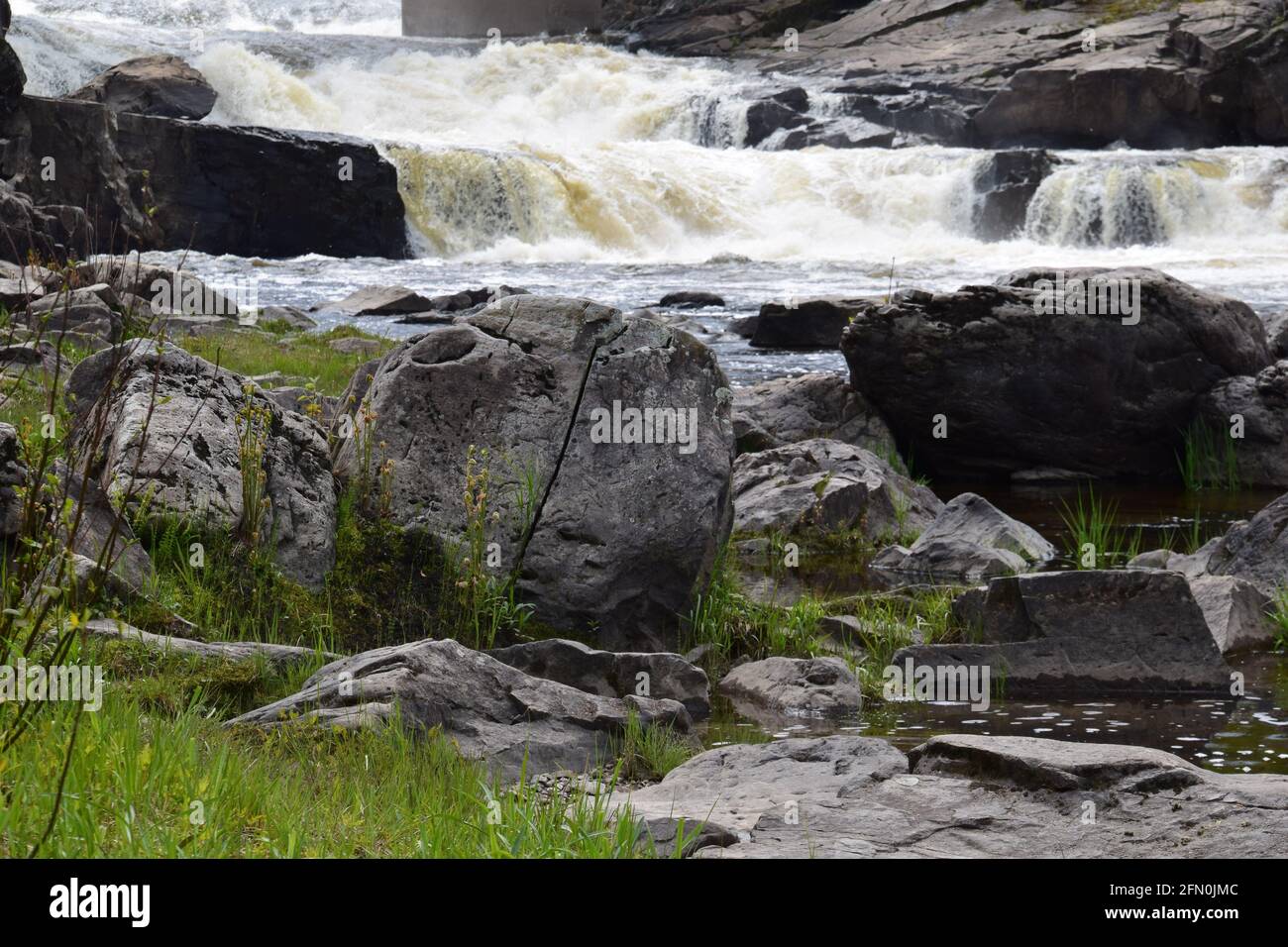 Scenic Maddington waterfalls in southern Quebec. This stream ends in the St-Lawrence waterway. However modest it’s cuteness is worth a caption. Stock Photo