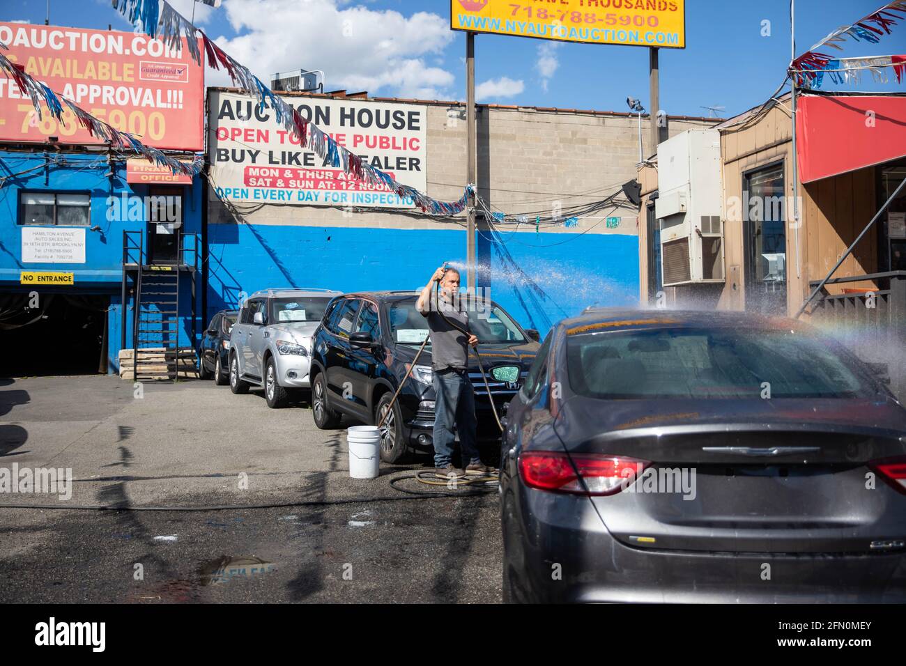 New York, USA. 12th May, 2021. A worker washes a car at Hamilton Avenue Auto Sales, a used car dealership in the Brooklyn borough of New York, the United States, on May 12, 2021. U.S. consumer prices rose 0.8 percent in April, with a 12-month increase of 4.2 percent, the U.S. Labor Department reported Wednesday. This marked the largest 12-month growth since a 4.9-percent increase for the period ending September 2008, according to the report. Credit: Michael Nagle/Xinhua/Alamy Live News Stock Photo