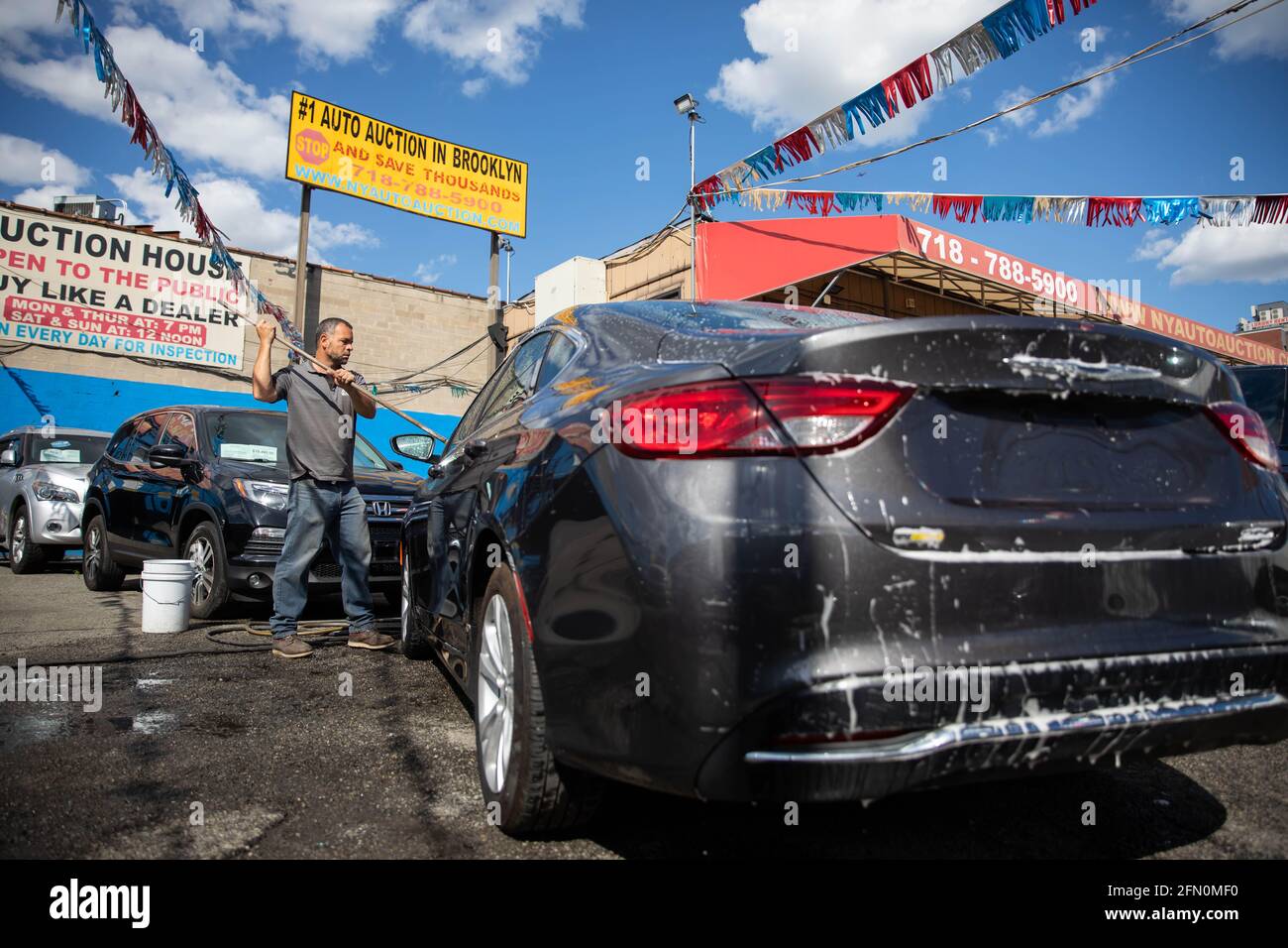 New York, USA. 12th May, 2021. A worker washes a car at Hamilton Avenue Auto Sales, a used car dealership in the Brooklyn borough of New York, the United States, on May 12, 2021. U.S. consumer prices rose 0.8 percent in April, with a 12-month increase of 4.2 percent, the U.S. Labor Department reported Wednesday. This marked the largest 12-month growth since a 4.9-percent increase for the period ending September 2008, according to the report. Credit: Michael Nagle/Xinhua/Alamy Live News Stock Photo