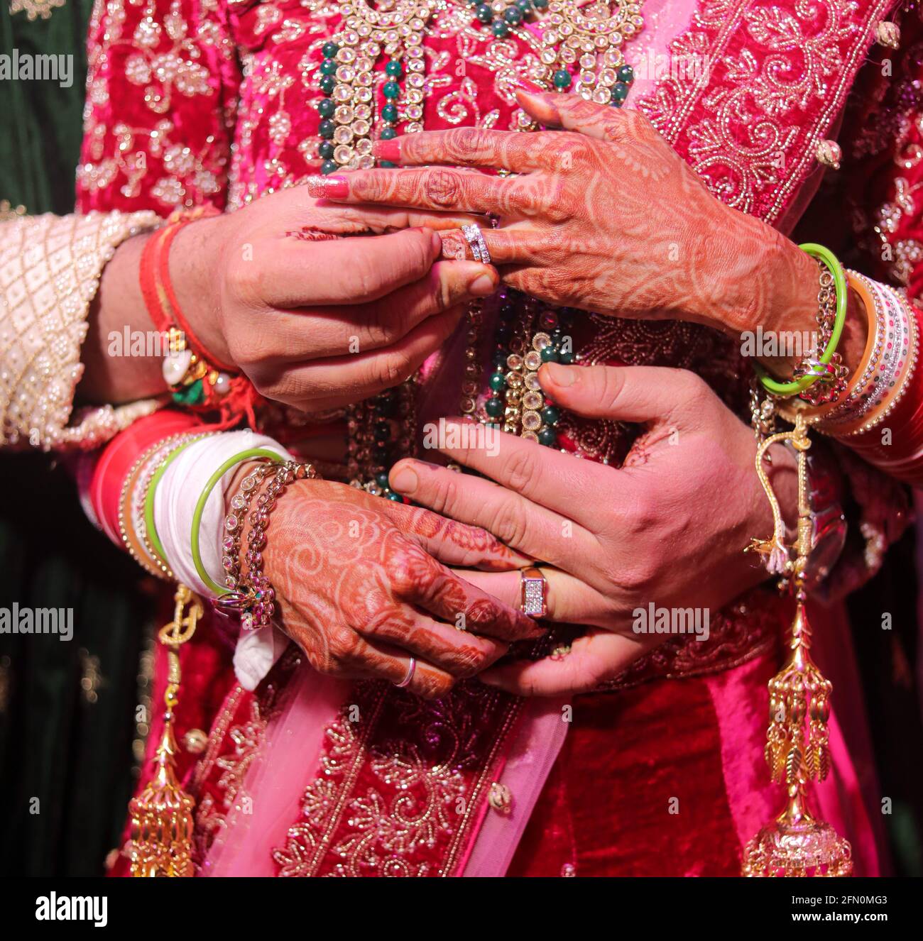 indian wedding couple hand with engagement rings 2FN0MG3