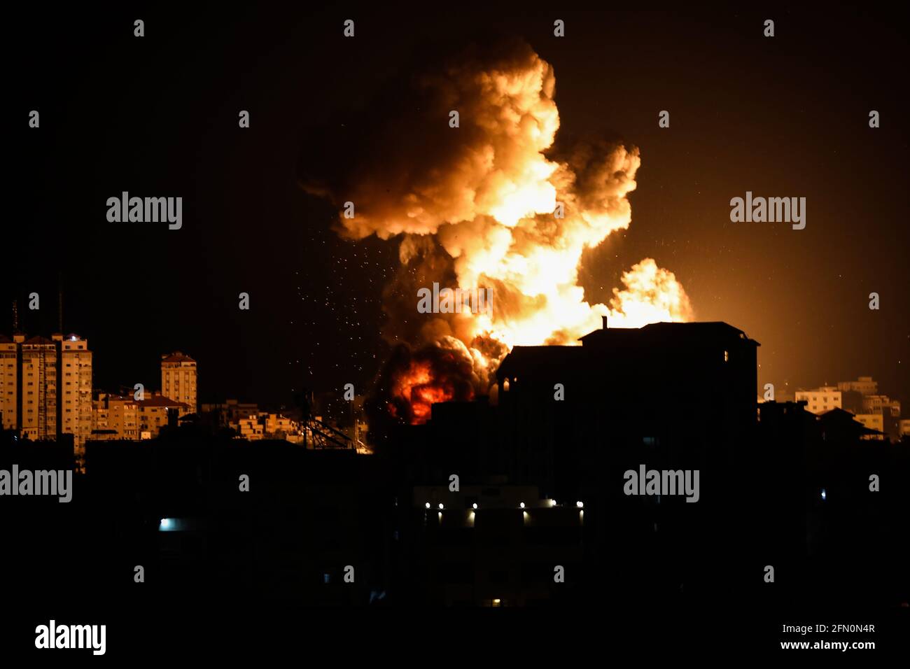 Gaza, Palestine. 12th May, 2021. Smoke and flames rise from a building during an Israeli air strike amid a flare-up of Israeli-Palestinian violence in Gaza City. Credit: SOPA Images Limited/Alamy Live News Stock Photo