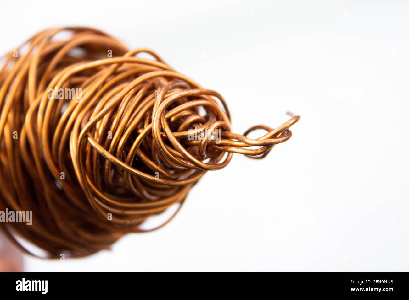 Copper wire . The wire coil is rolled up. The red copper wire is