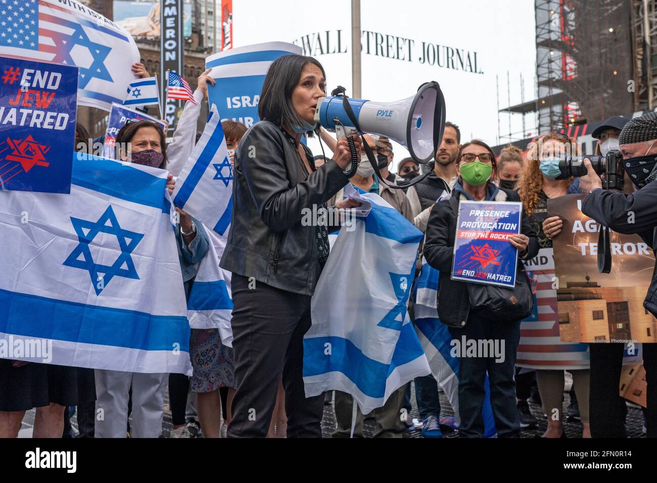 NEW YORK, NY - MAY 12: Tal Shuster speaks to the crowd as the Israeli-American Council (IAC) and other American Jewish groups gather in Times Square in solidarity with Israel on May 12, 2021 in New York City. Rallies across America show solidarity with Israel and its people. U.S. President Joe Biden said today, May 12, that Israel has a right to defend itself but after speaking with Prime Minister Benjamin Netanyahu he hopes violent clashes with Palestinians will end quickly. Credit: Ron Adar/Alamy Live News Stock Photo