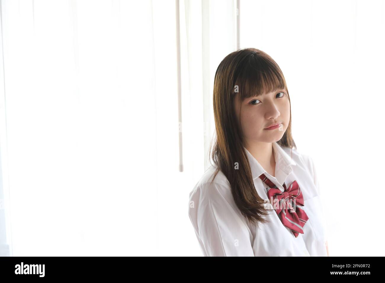 Portrait japanese school girl uniform in white tone bed room Stock ...