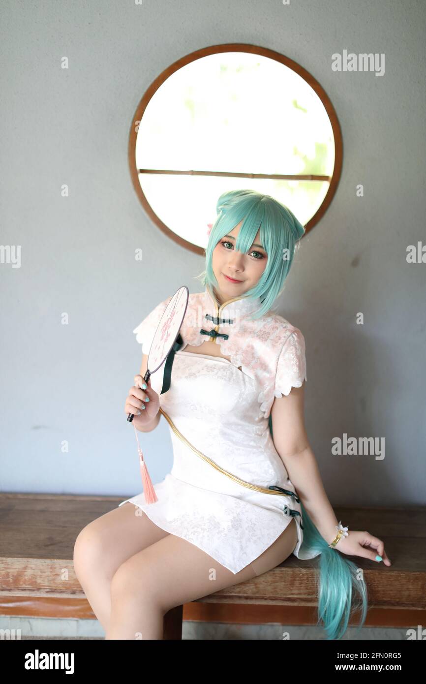 Japan anime cosplay portrait of a girl with chinese dress costume in  chinese garden Stock Photo - Alamy