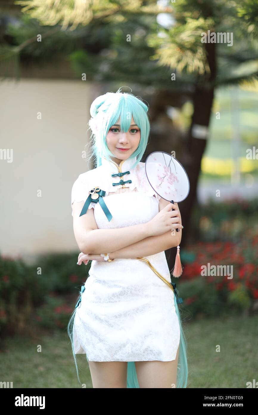 Japan anime cosplay portrait of a girl with chinese dress costume in chinese  garden Stock Photo - Alamy