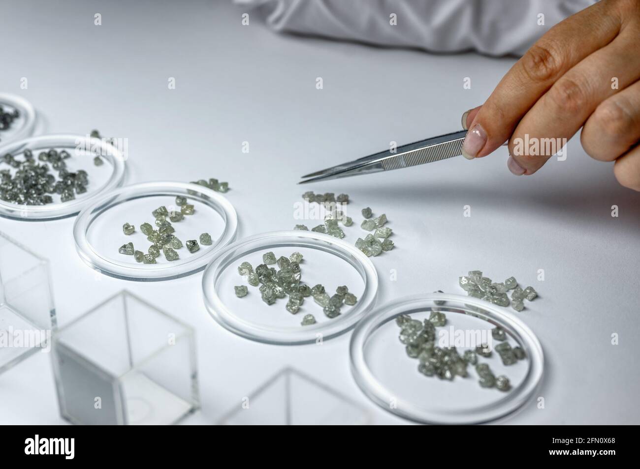 The process of manual sorting of diamonds. Gemstones are sorted by ...