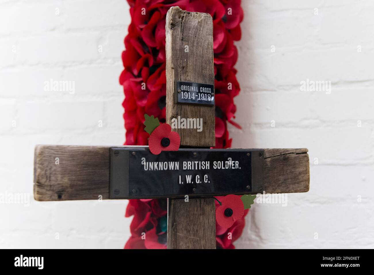 An original cross of an unknown soldier killed in the Fisrt World War at, The Royal British Legion's Poppy Factory, 20 Petersham Road, Richmond, London, UK. The Poppy Factory employs ex-service personnel to makes poppies, remembrance crosses, sprays and wreaths for The Royal British Legion’s annual Appeal and Remembrance Day. The Poppy Factory is also responsible for planting and hosting The Field of Remembrance at Westminster Abbey. The Royal British Legion's Poppy Factory, 20 Petersham Road, London, UK.  16 Oct 2013 Stock Photo
