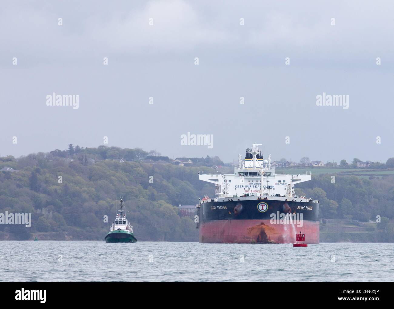 Whitegate, Cork, Ireland. 12th May, 2021. Oil tanker Elias Tsakos is assisted by tugboats Titan and Alex as she slowly manoeuvres away from the jetty and departs the harour on her way to Scapa Flow at Whitegate, Co. Cork, Ireland.  - Credit; David Creedon / Alamy Live News Stock Photo