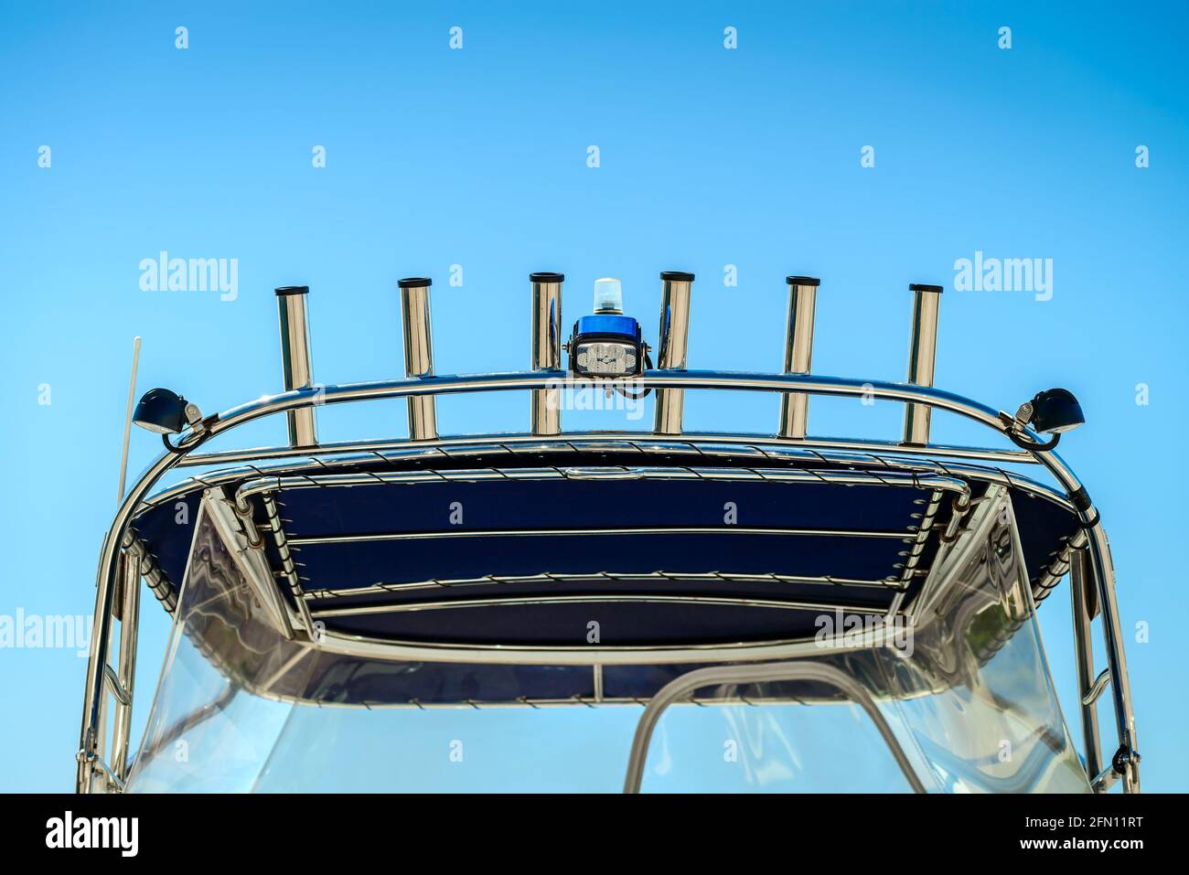 https://c8.alamy.com/comp/2FN11RT/fishing-rod-holders-installed-on-top-of-the-boat-canopy-2FN11RT.jpg