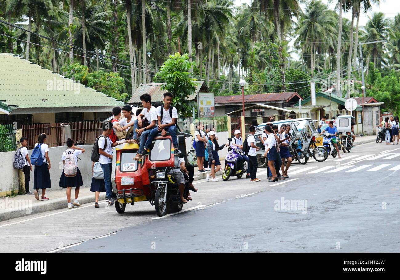 School students riding a tricycle in Sorsogon province in the Philippines. Stock Photo