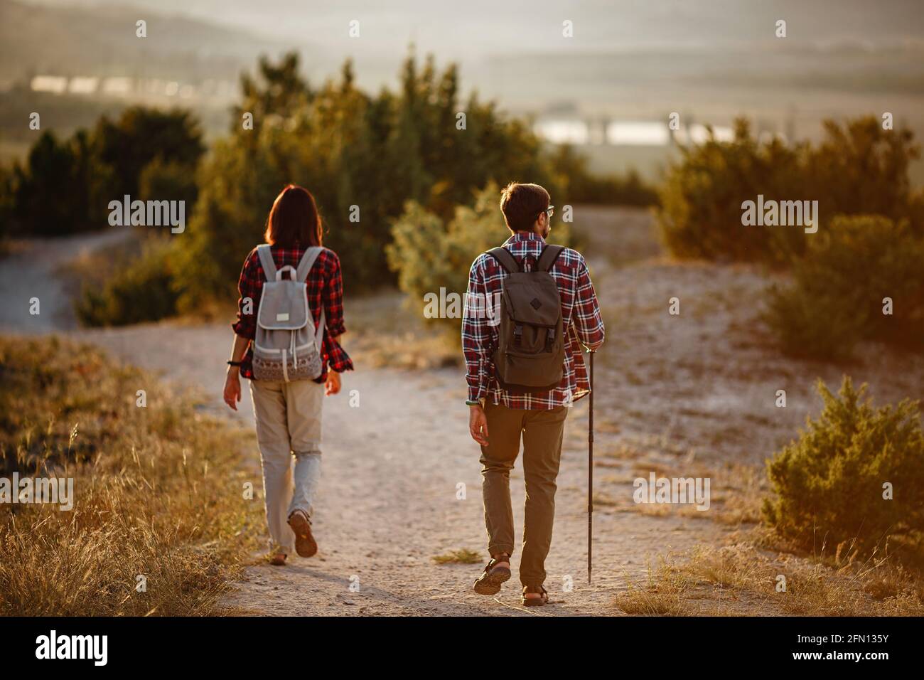 Portrait of happy young couple having fun on their hiking trip ...