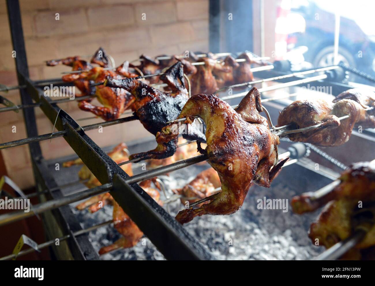 Lechon manok cooked over charcoal spit. Legazpi, Philippines. Stock Photo