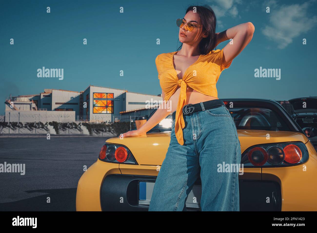 Yellow top with blue jeans hi-res stock 