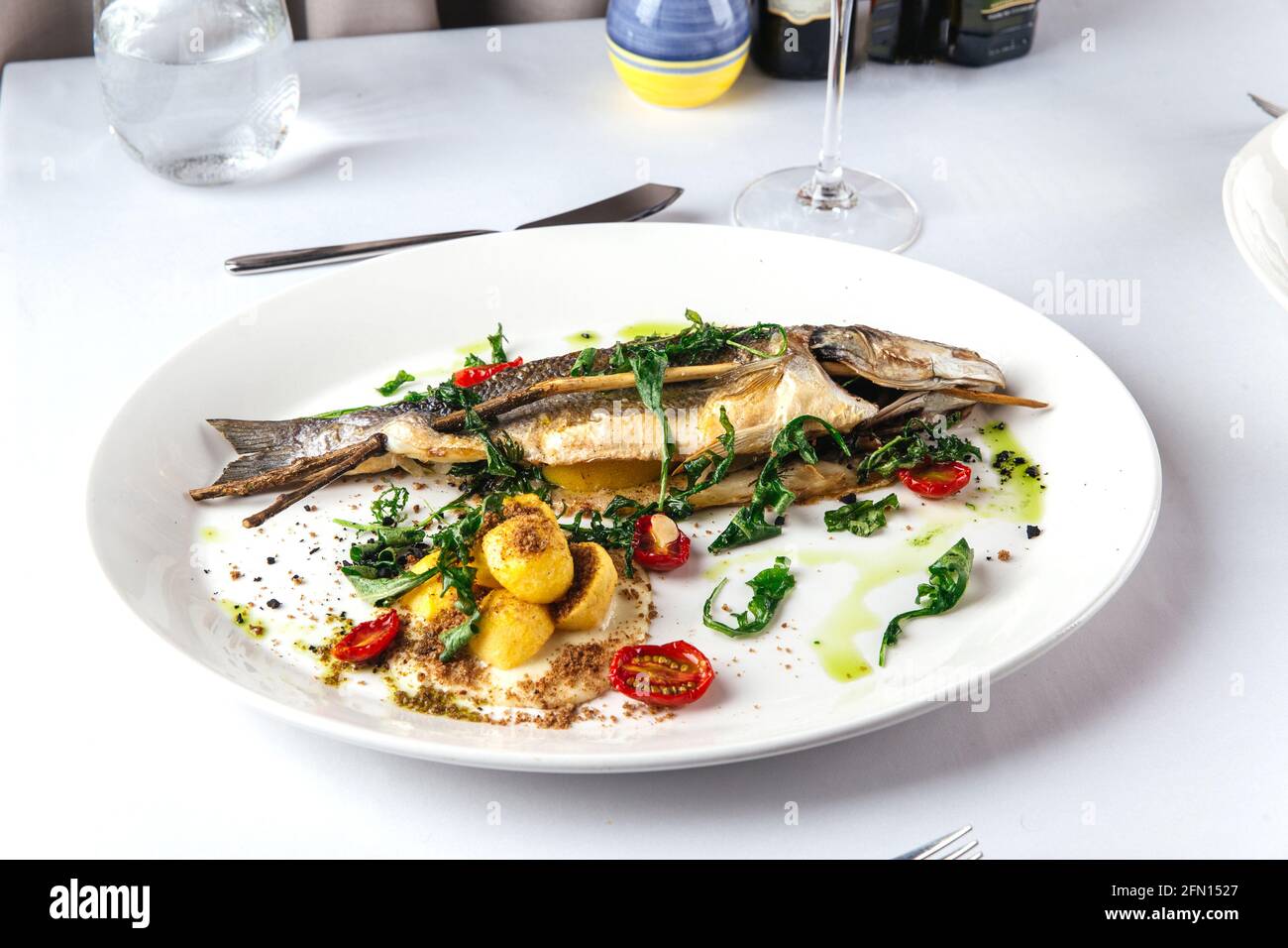 Gourmet roasted sea bass on the restaurant table Stock Photo