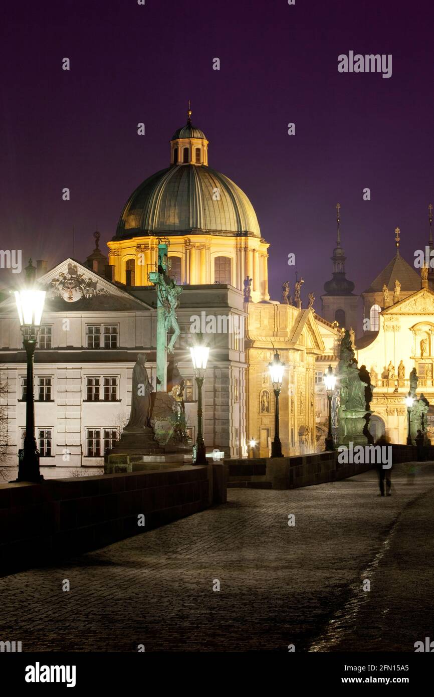 Prague, Czechia - Charles Bridge and St. Francis church at dusk. Stock Photo