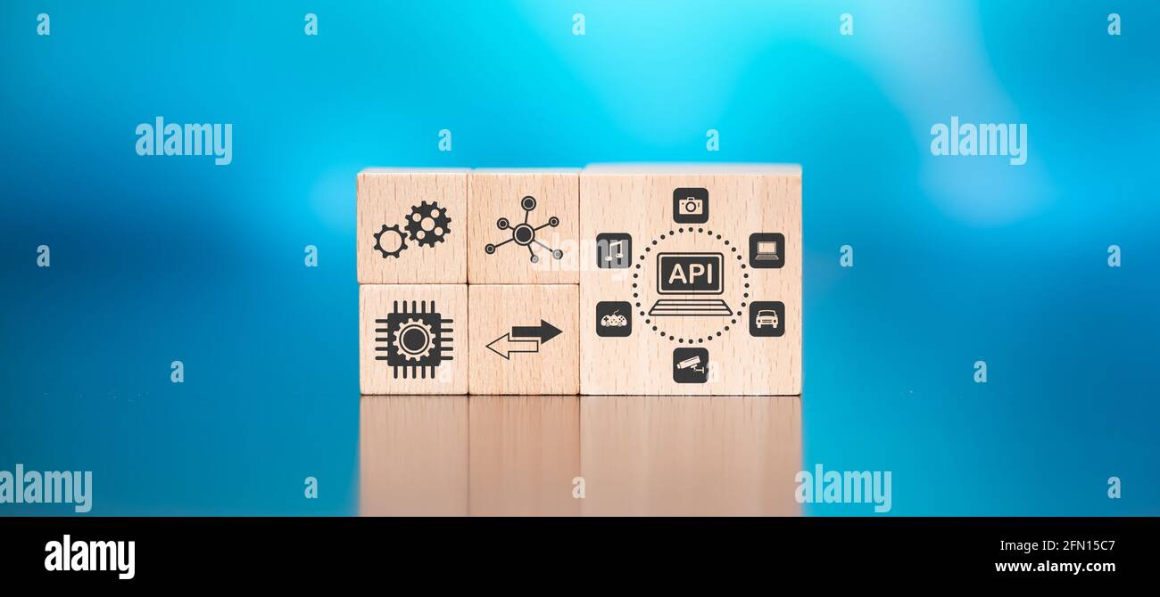 Wooden blocks with symbol of api concept on blue background Stock Photo ...
