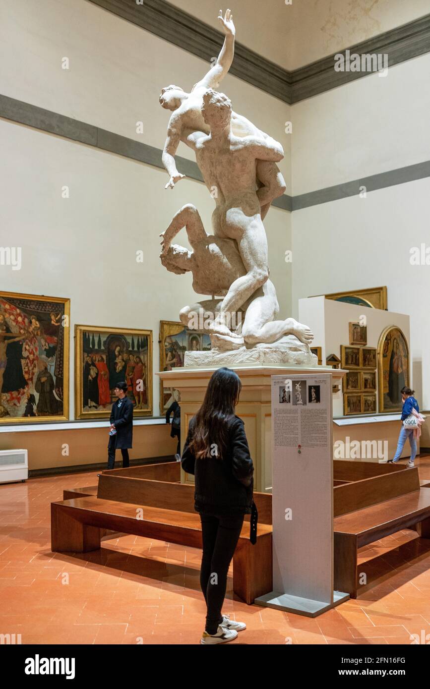 Florence, Italy, Accademia Gallery, vistors in the hall with the sculpture Il Ratto Delle Sabine (the rape of the sabine women) by Giambologna Stock Photo