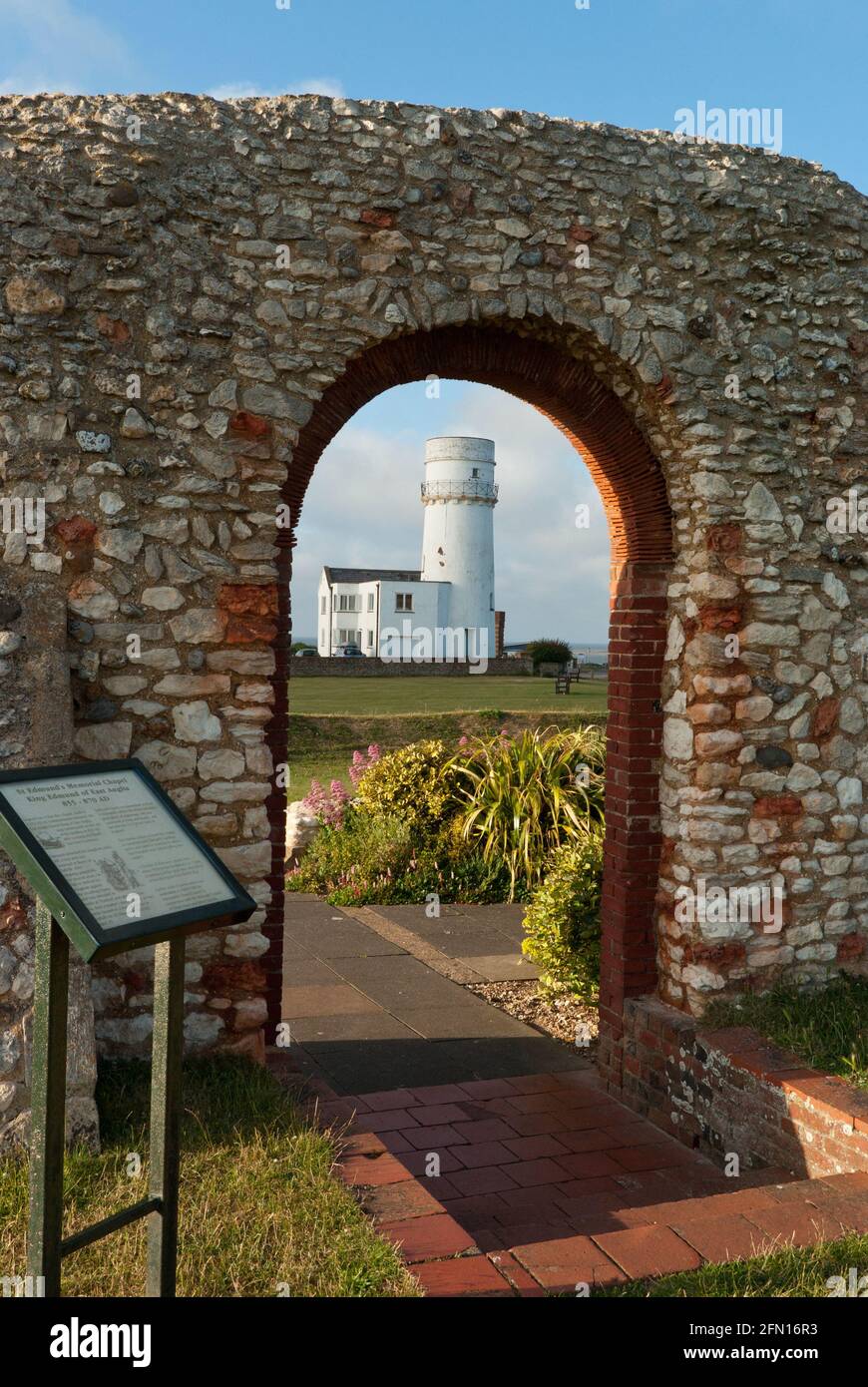 Old Hunstanton Lighthouse, framed by the ruins of St Edmunds chapel, on the cliff top, Hunstanton, Norfolk, UK Stock Photo