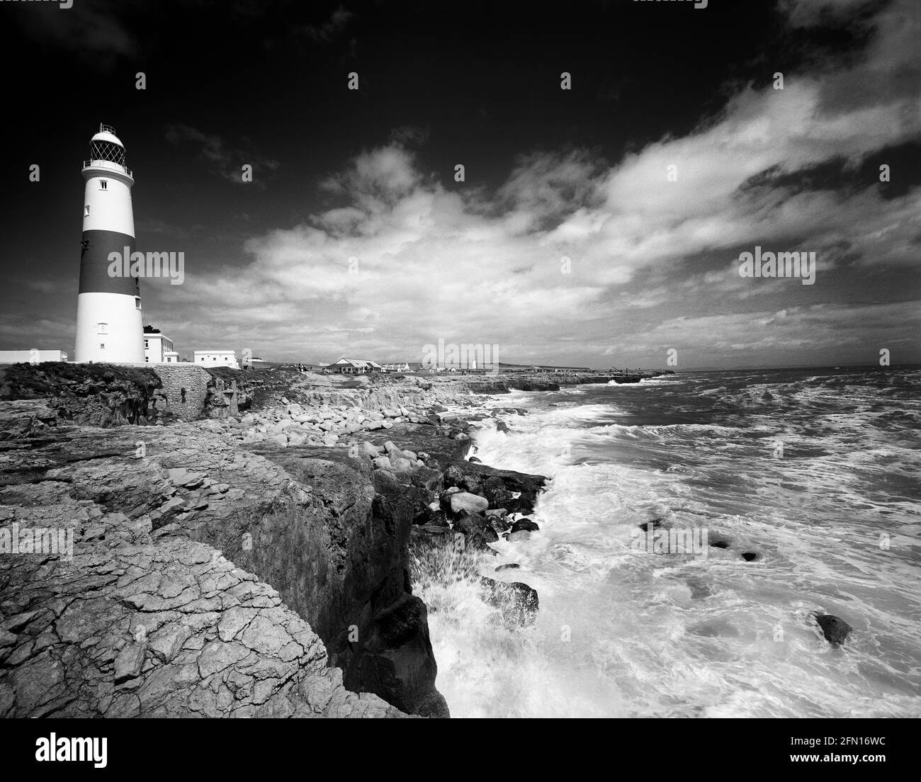 Black and White Portland Bill lighthouse rocks and stormy sea dramatic clouds, Isle of Portland, Dorset, England, UK copy space Stock Photo