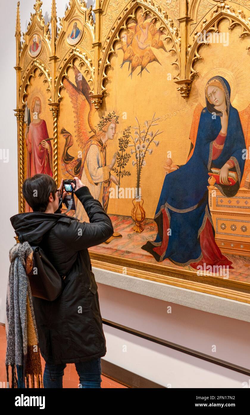 Florence, Italy, The Uffizi Gallery, sacred paintings from the fourteenth century, with a visitor Stock Photo