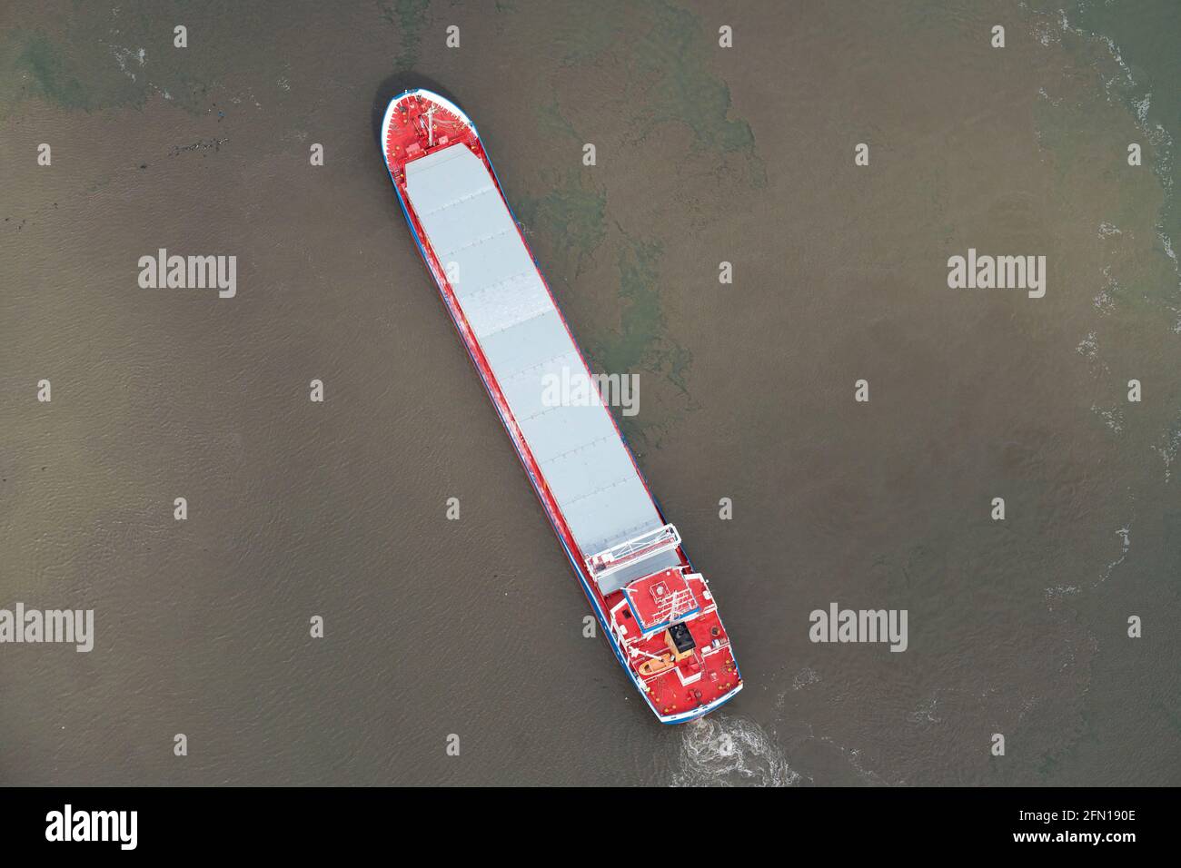 Overhead view of a ship departing, Seaforth Docks, River Mersey, Liverpool, North West England, UK. shot from the air Stock Photo