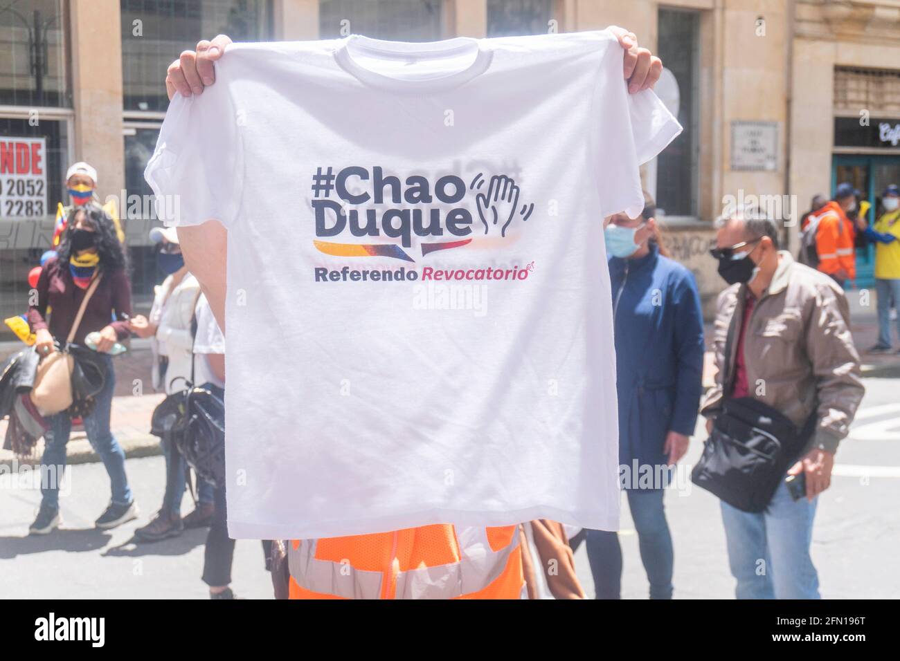 May 12, 2021: A person shows a T-shirt stamped with the text ''Chao Duque'' in Bogota. Credit: Daniel Garzon Herazo/ZUMA Wire/Alamy Live News Stock Photo